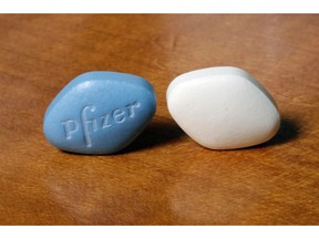 FILE- This Dec. 4, 2017, file photo shows a tablet of Pfizer's Viagra, left, and the company's generic version, sildenafil citrate, at Pfizer Inc., headquarters in New York. Pfizer Inc. reports earnings Tuesday, Oct. 30, 2018.