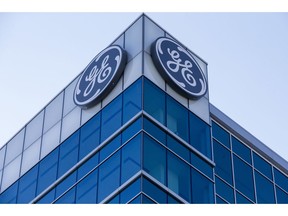 FILE - In this Jan. 16, 2018 file photo, the General Electric logo is displayed at the top of their Global Operations Center, in the Banks development of downtown Cincinnati. General Electric Co. reports earnings Tuesday, Oct. 30.