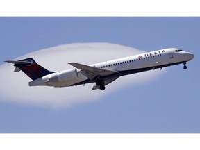 FILE- In this May 24, 2018, file photo a Delta Air Lines passenger jet plane, a Boeing 717-200 model, approaches Logan Airport in Boston. Delta is partnering with a pet travel pod startup, as it changes its prices and policy for transporting passengers' animal companions, the airline announced Tuesday, Oct. 2.