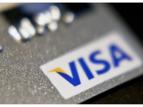 FILE- This June 13, 2018, file photo shows a Visa logo on a credit card in Zelienople, Pa. Visa Inc. reports earnings Wednesday, Oct. 24.