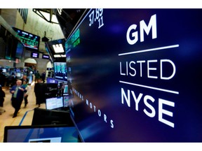 FILE - In this April 23, 2018, file photo, the logo for General Motors appears above a trading post on the floor of the New York Stock Exchange. General Motors reports earnings Wednesday, Oct. 31.