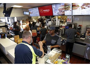 FILE- In this July 18, 2018, file photo a customer gets his coffee at a McDonald's restaurant in Pittsburgh. On Wednesday, Oct. 3, the Institute for Supply Management, a trade group of purchasing managers, issues its index of non-manufacturing activity for September.