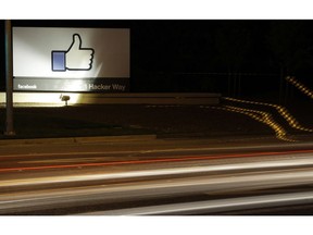 FILE - In this June 7, 2013, file photo, the Facebook "like" symbol is on display on a sign outside the company's headquarters in Menlo Park, Calif. Facebook says it has purged more than 800 U.S. pages and accounts for spamming users with garbage links and clickbait.