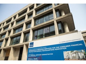 FILE- In this Aug. 27, 2018, file photo a sign stands at the construction site for the Consumer Financial Protection Bureau's new headquarters in Washington. The nation's financial watchdog has opened a formal investigation into writings and comments by Eric Blankenstein, a Republican appointee overseeing the agency's anti-discrimination efforts, which he alleged that most hate crimes were fake and argued that using racial epithets did not mean a person was racist.