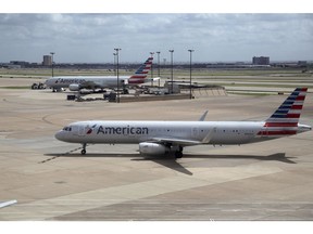 FILE - In this June 16, 2018 file photo, American Airlines aircrafts are seen at Dallas-Fort Worth International Airport in Grapevine, Texas. American Airlines reports earnings Thursday, Oct. 25.