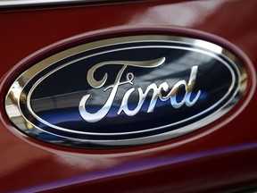 FILE- This Feb. 15, 2018, photo shows a Ford logo on a 2018 Expedition 4x4 on display at the Pittsburgh Auto Show. U.S. auto companies such as General Motors, Tesla and Ford faltered this year in Consumer Reports' reliability rankings as readers reported more mechanical trouble and fewer problems with infotainment systems.