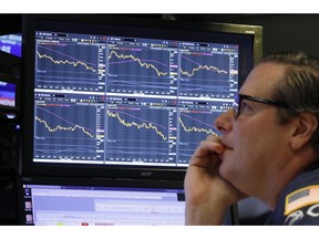 FILE- In this Oct. 10, 2018, file photo specialist Gregg Maloney works at his post on the floor of the New York Stock Exchange. So far this month, high-growth stocks in the Russell 3000 index have plummeted 11.3 percent, versus 7.5 percent for their lower-priced counterparts known as "value" stocks, as of Wednesday. It's the biggest such monthly gap in performance in a decade.