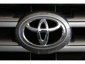 FILE- This Feb. 11, 2016, file photo shows a Toyota logo on the hood of a 2016 Toyota Sequoia on display at the Pittsburgh International Auto Show in Pittsburgh. Toyota is recalling nearly 188,000 pickup trucks, SUVs and cars worldwide because the air bags may not inflate in a crash. The recall covers 2018 and 2019 Tundra pickups and Sequoia SUVs as well as 2019 Avalon sedans.