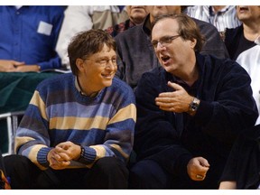 FILE - In this March 11, 2003 file photo, Microsoft Chairman Bill Gates, left, chats with Portland Trail Blazers owner and former business partner Paul Allen during a game between the Trail Blazers and Seattle SuperSonics in Seattle.  Allen, billionaire owner of the Trail Blazers and the Seattle Seahawks and Microsoft co-founder, died Monday, Oct. 15, 2018 at age 65. Earlier this month Allen said the cancer he was treated for in 2009, non-Hodgkin's lymphoma, had returned.