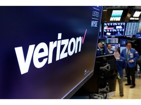 FILE- This April 23, 2018, file photo shows the logo for Verizon above a trading post on the floor of the New York Stock Exchange. Cellular companies such as Verizon are looking to challenge traditional cable companies with residential internet service that promises to be ultra-fast, affordable and wireless. Using an emerging wireless technology known as 5G, Verizon's 5G Home service provides an alternative to cable for connecting laptops, phones, TVs and other devices over Wi-Fi. It launches in four U.S. cities on Monday, Oct. 1.