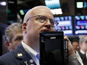 FILE- In this Oct. 11, 2018, file photo trader Thomas Ferrigno works on the floor of the New York Stock Exchange. The U.S. stock market opens at 9:30 a.m. EDT on Tuesday, Oct. 16.