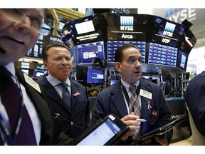FILE- In this Tuesday, Oct. 2, 2018, file photo Tommy Kalikas, right, works with fellow traders on the floor of the New York Stock Exchange. The U.S. stock market opens at 9:30 a.m. EDT on Thursday, Oct. 4.