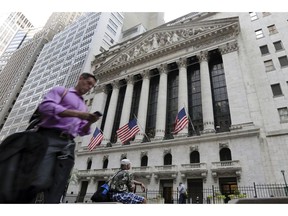 FILE - In this June 24, 2016, file photo, a man walks by the New York Stock Exchange. The U.S. stock market opens at 9:30 a.m. EDT on Friday, Oct. 12, 2018.