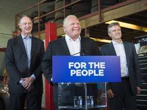 Ontario Premier Doug Ford, centre, Rod Phillips, the environment minister, right, and John Yakabuski, the transportation minister, announce the decision to cancel the Ontario Drive Clean program.