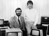 Microsoft Corp. co-founders Paul Allen, and Bill Gates pose with International Business Machines personal computers after signing a software contract with IBM in Oct. 1981.