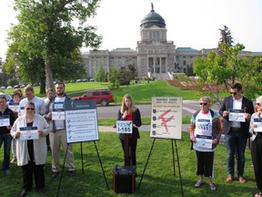 FILE--In this Aug. 22, 2018, file photo, Amanda Cahill of the American Heart Association speaks to a rally in support of a ballot initiative to raise Montana's tobacco taxes in Helena, Mont. Industry-funded opponents of Montana citizen's initiatives to raise the state's tobacco tax and add new mining regulations are vastly outspending the measures' supporters to put their messages in front of voters about a month before Election Day, according to campaign finance reports.