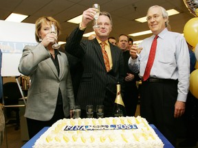 Diane Francis, Doug Kelly and Terry Corcoran, right, raise their glasses as staffers gather around the cake and champagne to celebrate 100 years of the Financial Post in 2007.