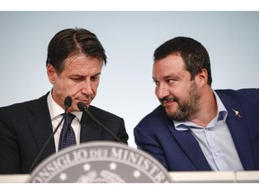 Italy's Interior Minister and Deputy-Premier Matteo Salvini, right, and Italian Premier Giuseppe Conte attend a press conference on Italy's budget law, at Chigi Palace Premier office, in Rome, Monday, Oct. 15, 2018.