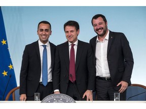 Left to right: vice premier Luigi Di Maio, premier Giuseppe Conte and vice premier Matteo Salvini, pose as they arrive for a press conference at Chigi's Palace, in Rome, Saturday, Oct. 20 2018. Italy's government vowed Saturday to engage in constructive talks with the European Union as it still gave final approval to a rule-busting budget and brushed off a ratings downgrade triggered by its higher-than-expected deficit targets.