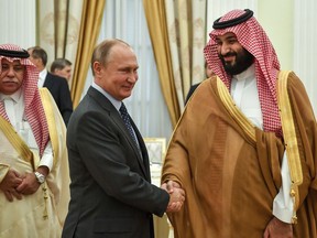 President Vladimir Putin, shakes hands with Saudi Arabian Crown Prince Mohammed bin Salman, right, during their meeting in Moscow, Russia in 2018.