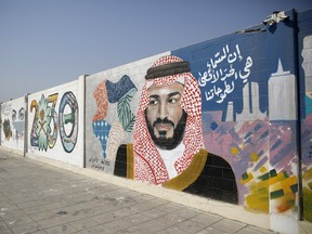 A wall mural displays the '2030 Vision' logo and Saudi Arabia's Crown Prince Mohammed bin Salman in Dhahran, Saudi Arabia.