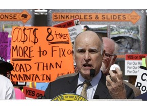 FILE - In this April 5, 2017, file photo, California Gov. Jerry Brown urges lawmakers to approve SB1, a bill to raise gas and car taxes to generate $5 billion-a-year for road repairs, during a rally in Sacramento, Calif. As the political battle to overturn the gas tax increase intensified, the state transportation agency coordinated frequently with the public relations firm working to block the repeal on behalf of unions, construction companies and local governments, emails obtained by The Associated Press show.