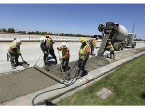 FILE In this July 11, 2018 file photo, workers repave a street in Roseville, Calif., partially funded by a gas tax hike passed by the Legislature in 2017. Leaders of the Proposition 6 campaign to repeal California's recent gas tax increase are asking the federal government to investigate their claims that public resources have been used against them. A spokeswoman for the anti-Proposition 6 campaign countered the allegations, saying the campaign follows all laws.