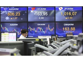 A currency trader works at the foreign exchange dealing room of the KEB Hana Bank headquarters in Seoul, South Korea, Tuesday, Oct. 30, 2018. Asian shares were mostly higher on Tuesday as traders took the weaker yuan as a sign that Chinese exports can remain competitive even if a trade dispute with Washington heats up.