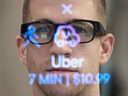 Thalmic Labs co-founder Aaron Grant wears the company's soon to be released North glasses while looking through a display that shows how a view through the glasses looks.