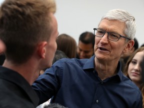 Apple CEO Tim Cook greets a visitor during an Apple special event at the Steve Jobs Theatre on September 12, 2018 in Cupertino, California. Cook is in China this week.