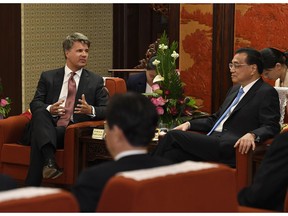 Chinese Premier Li Keqiang, right , meets with Harald Kruger, CEO and chairman of the Board of Management of BMW AG, left back, at the Zhongnanhai leadership compound in Beijing Wednesday, Oct. 10, 2018.
