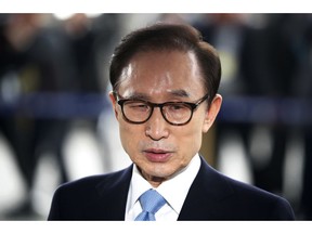 FILE - In this March 14, 2018, file photo, former South Korean President Lee Myung-bak arrives for questioning over bribery allegations at the Seoul Central District Prosecutors' Office in Seoul, South Korea.  A South Korean court has sentenced former President Lee to 15 years in prison over a slew of corruption charges. The Seoul Central District Court issued the sentence on Friday, Oct. 5,  after convicting Lee of bribery, embezzlement and other charges.