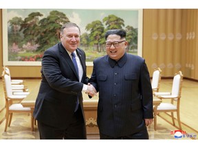 FILE - In this May 9, 2018, file photo provided by the North Korean government, U.S. Secretary of State Mike Pompeo, left, shakes hands with North Korean leader Kim Jong Un during a meeting at Workers' Party of Korea headquarters in Pyongyang, North Korea. North Korea warned Washington through its state media Tuesday, Oct. 2, that a declaration ending the Korean War shouldn't be seen as a bargaining chip in denuclearization talks -- but suggested lifting sanctions might be. Independent journalists were not given access to cover the event depicted in this image distributed by the North Korean government. The content of this image is as provided and cannot be independently verified. Korean language watermark on image as provided by source reads: "KCNA" which is the abbreviation for Korean Central News Agency. (Korean Central News Agency/Korea News Service via AP, File)