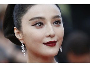 FILE - In this May 24, 2017, file photo, Fan Bingbing poses for photographers as she arrives for the screening of the film The Beguiled at the 70th international film festival, Cannes, southern France. Chinese media said on Wednesday, Oct. 3, 2018, tax authorities ordered X-Men star Fan to pay taxes and fines worth hundreds of millions of yuan but would spare her from criminal prosecution.