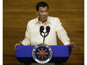 FILE - In this July 23, 2018, file photo, Philippine President Rodrigo Duterte gestures during his third State of the Nation Address at the House of Representatives in Quezon city, Philippines. Duterte put the corruption-plagued Bureau of Customs temporarily under military control amid a scandal after two huge shipments of illegal drugs reportedly slipped past through the port of Manila.