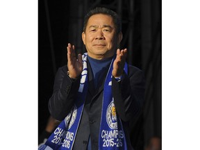 FILE - In this May 16, 2016, file photo, Leicester City chairman Vichai Srivaddhanaprabha applaud fans at Victoria Park, Leicester, England, during their victory parade to celebrate winning the English Premier league title in Leicester, England. Thai billionaire and Leicester City owner Srivaddhanaprabha, who died when his helicopter crashed in a parking lot next to the soccer club's stadium, was known to fans as a smiling, benevolent man who gave away free beers and hot dogs on his birthday and brought the club its fairytale English Premier League title in 2016. He was 60.