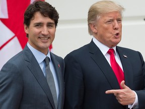 In this file photo taken on October 11, 2017 U.S. President Donald Trump  welcomes Canadian Prime Minister Justin Trudeau at the White House in Washington, D.C.