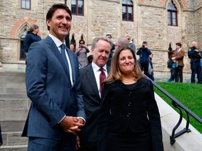 Prime Minister Justin Trudeau, left, Canada's chief trade negotiator Steve Verheul, centre, and Minister of Foreign Affairs Chrystia Freeland, right, walk to a press conference to announce the new USMCA trade pact between Canada, the United States, and Mexico in Ottawa, October 1, 2018.