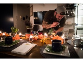 Chef Travis Petersen uses a dropper to add THC distillate to an amuse bouche of toasted farro and young pine broth before guests arrive for a multi-course cannabis-infused meal, in Vancouver, on Thursday October 11, 2018. One of the first questions Petersen asks guests as they arrive to his supper club at a semi-secret Vancouver location revealed to them shortly before the event is how they would gauge their cannabis tolerance. The 34-year-old former "MasterChef Canada" contestant will then dose the forthcoming multi-course dinner with the appropriate amount of THC and CBD, cannabis's psychoactive and non-psychoactive components respectively.