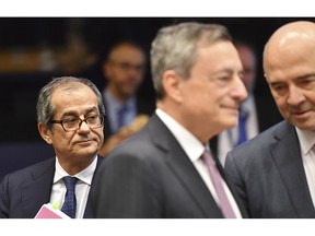 Italian Finance Minister Giovanni Tria, left, attends a round table meeting of eurogroup finance ministers at the European Council building in Luxembourg, Monday, Oct. 1, 2018.