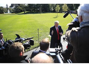 President Donald Trump speaks to reporters before leaving the White House in Washington, Monday, Oct. 22, 2018 to attend a campaign rally in Houston, Texas.