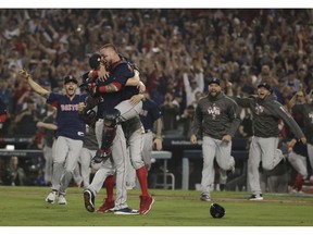 The Boston Red Sox celebrate after Game 5 of baseball's World Series against the Los Angeles Dodgers on Sunday, Oct. 28, 2018, in Los Angeles. The Red Sox won 5-1 to win the series 4 game to 1.