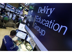 FILE - In this Jan. 27, 2016, file photo, Specialist Neil Gallagher works at the post that handles DeVry Education Group, on the floor of the New York Stock Exchange. A little-known venture capitalist is on the verge of acquiring one of the country's biggest for-profit colleges, a transaction that would put him in control of a troubled national chain vastly larger than the tiny California school he currently owns.