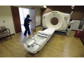 FILE - In this Jan. 9, 2013, file photo, a CT scan technician prepares for a patient at the Silver Cross Emergency Care Center in Homer Glen, Ill. The Trump administration is quietly trying to weaken radiation rules, relying on scientific outliers who argue that a little radiation damage is actually good for you _ like a little bit of sunlight.