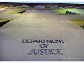 FILE - In this May 14, 2013, file photo, the Department of Justice headquarters building in Washington is photographed early in the morning. The Trump administration has stepped up scrutiny of asbestos trust funds out of concern of fraud and abuse. The Justice Department worries the pots of money intended to help people exposed to the hazardous substance are being depleted by fraudulent claims _ harming victims, businesses and the government.