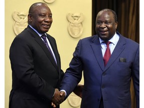 South African President Cyril Ramaphosa, left, shakes hand with newly elected Finance Minister, Tito Mboweni, in Cape Town, South Africa, Tuesday, Oct.9 2018. Former finance minister Nhlanhla Nene resigned after acknowledging missteps during the scandal-tainted tenure of former president Jacob Zuma. (AP Photo)