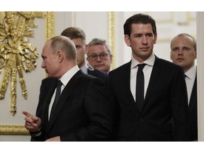 Russian President Vladimir Putin and Austria's Federal Chancellor Sebastian Kurz walk during their meeting in the State Hermitage museum in St.Petersburg, Russia, Wednesday, Oct. 3, 2018.