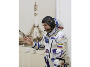 Russian cosmonaut Alexey Ovchinin, a member of the main crew to the International Space Station (ISS), walks to inspect his space suits prior to the launch of Soyuz-FG rocket at the Russian leased Baikonur cosmodrome, Kazakhstan, Thursday, Oct. 11, 2018.