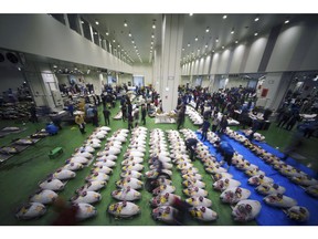 Prospective buyers bid frozen tunas during the first auction at the newly opened Toyosu Market, new site of Tokyo's fish market, in Tokyo Thursday, Oct. 11, 2018. Tokyo's famous fish market reopened Thursday at a new location but with an old tradition: the tuna auction.