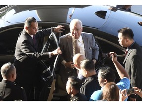 Former Malaysian Prime Minister Najib Razak gets off a car upon arrival at Kuala Lumpur High Court in Kuala Lumpur, Malaysia, Thursday, Oct. 25, 2018. Najib, along with two former high-ranking officials, faces fresh charges of criminal breach of trust involving the use of government funds.